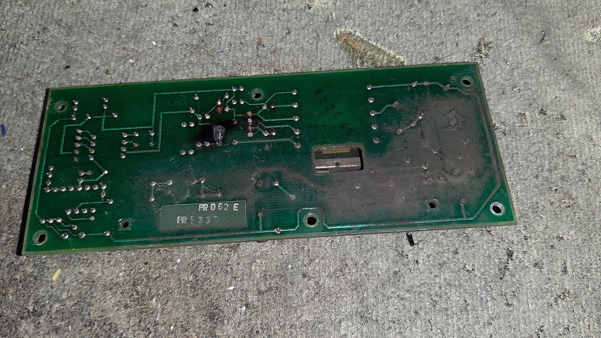 Blackish dust on charred printed circuit board